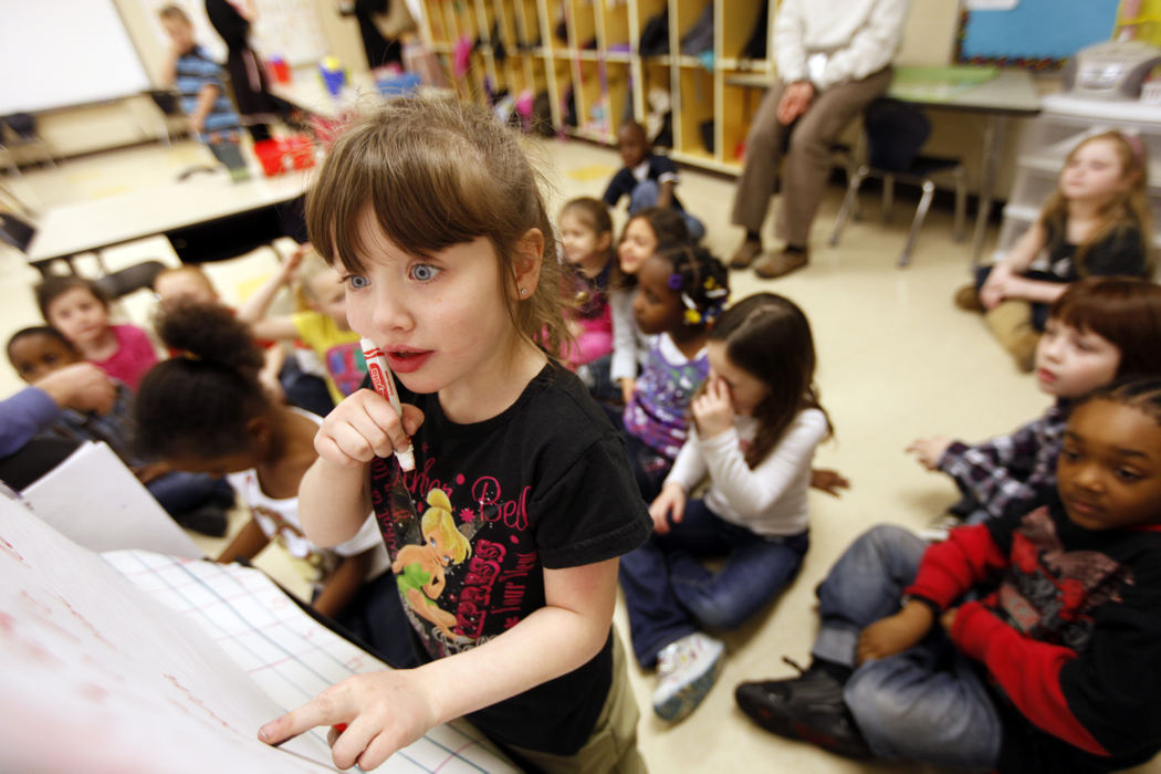 Feature - 3rd placeHamilton Elementary kindergartner Lynnzi Pack thinks about what she wants to write while she and her classmates take turns writing things that they love during a Valentine's Day celebration. (Shari Lewis / The Columbus Dispatch)