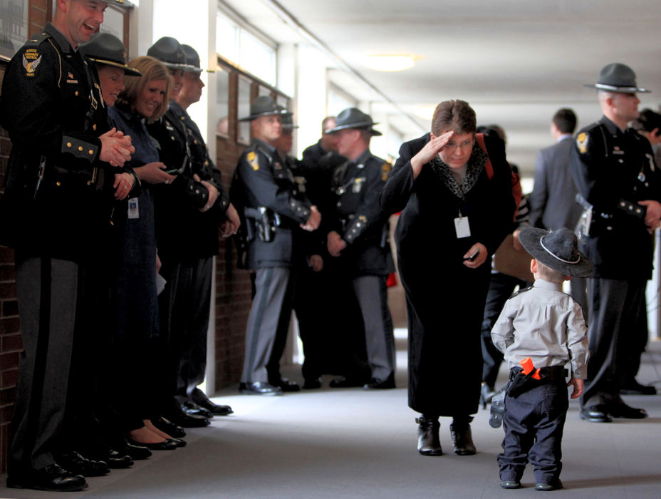 General News - 3rd placeAngi Lee, of the Department of Rehabilitaion and Correction salutes Mason Holden, 23 months, who was dressed like a State Trooper in honor of his dad's graduation at the 151st Academy Graduation. His dad Bryan Holden was sworn in as a State Trooper during a ceremony at the Ohio State Highway Patrol Academy. Mason and his dad are from Willard.  (Fred Squillante / The Columbus Dispatch)