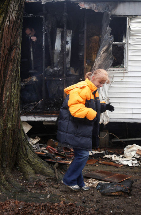 Spot News - 3rd placeLisa Evans (right) returned from the store to find her trailer burned up and fire investigators in her bedroom (left) on at 3527 Edson Drive on the West side. Evans said her 6 year old was not home at the time and that she is a single mom with no insurance and had just lost everything she had worked for.  (Tom Dodge / The Columbus Dispatch)