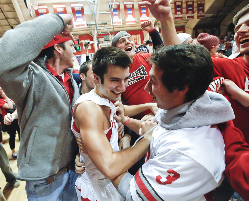 Story - 2nd placeSteven Newell (10) of Wittenberg is mobbed by fans who rushed the floor after the Tigers beat rival Wooster 68-62 in overtime at the Pam Evans Smith Arena in Springfield. (Barbara J. Perenic / Springfield News-Sun)