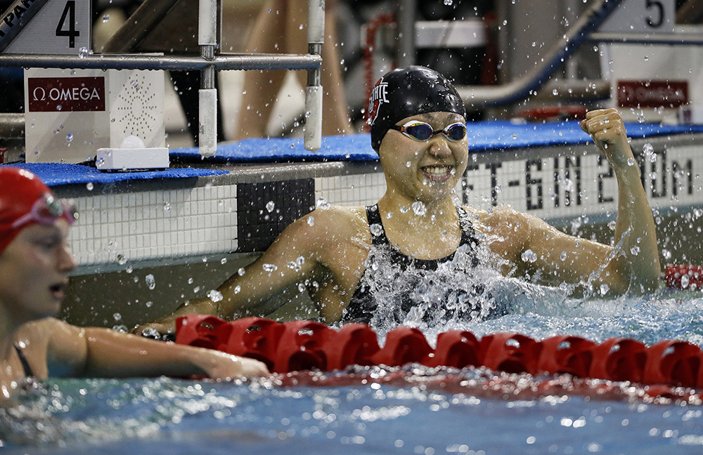 Ohio State senior Zhesi Li celebrates after winning the 50-yard freestyle beside Wisconsin's Marissa Berg during the Big Ten Swimming & Diving Championships at the McCorkle Aquatic Center on Ohio State's campus. Li's time of 21.28 set a pool and Big Ten meet record.  (Adam Cairns / The Columbus Dispatch)