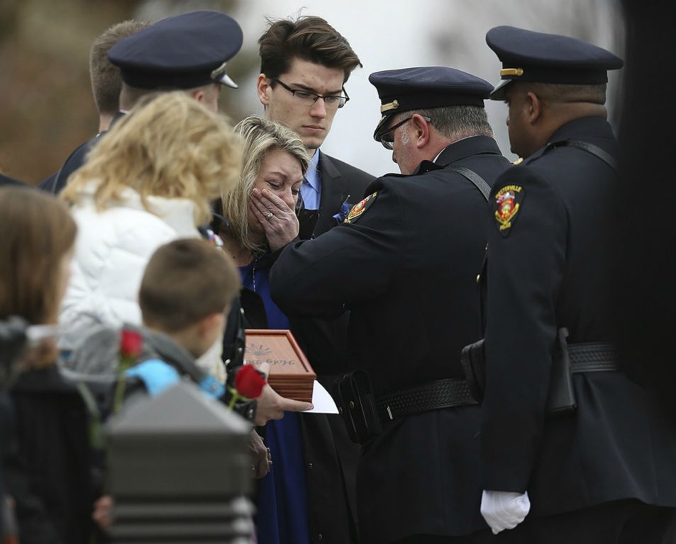 Linda Morelli cries as she is presented with the flag from Westerville Police Chief Joseph Morbitzer following the funeral service for Westerville police officers Eric Joering and her husband Anthony Morelli at St. Paul the Apostle Catholic church in Westerville. (Jonathan Quilter / The Columbus Dispatch)