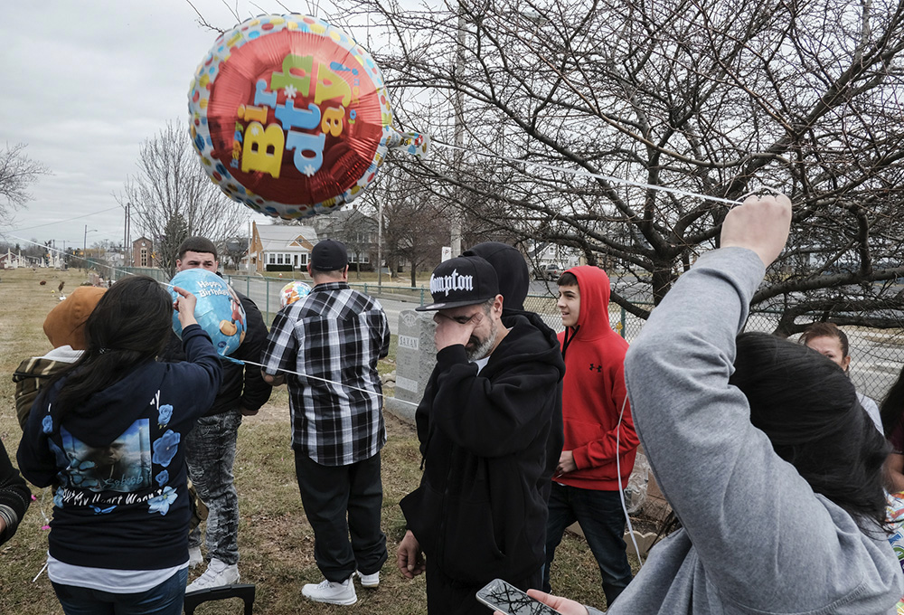 Sebastian Guerrero Sr., father of Sebastian Guerrero III, reacts as balloons are released in his son's birthday and memory at Mount Carmel Cemetery in Toledo. (Jeremy Wadsworth / The Blade)