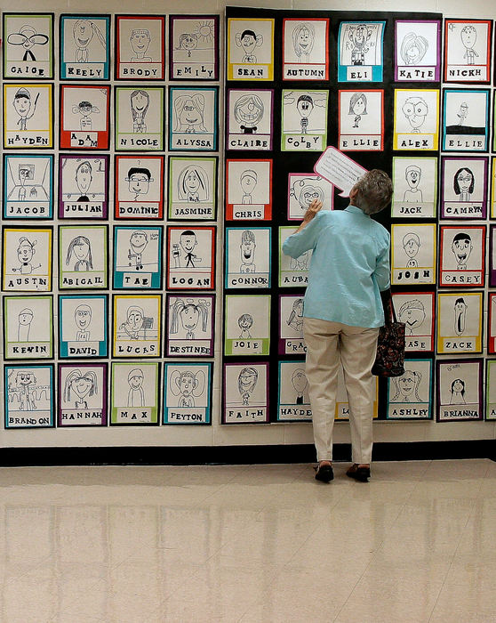 General News - HM - Grace Wood, 81, looks for her great-granddaughter's artwork at Edgewood Elementary's Fine Arts Night. (Eric George / ThisWeek Newspapers)