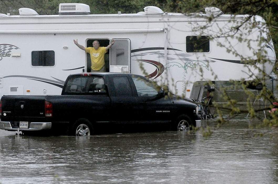 Spot News - 1st place - A resident at the Beaver Valley Resort near Springfield reacts to flooding outside his trailer. (Marshall Gorby / Springfield News-Sun)