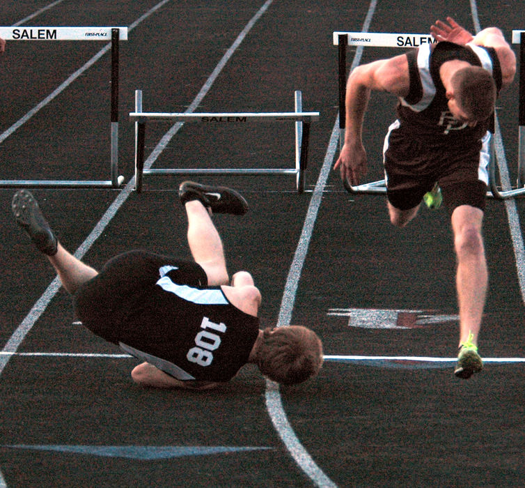 Sports - HM - Salem's Scott Lodge wins the 300-meter hurdles the hard way with a tumble as East Palestine's Mike Salyers finishes second at the Columbiana County Track and Field Meet at Salem's Reilly Stadium.  (Patricia Shaeffer / The (Lisbon) Morning Journal)