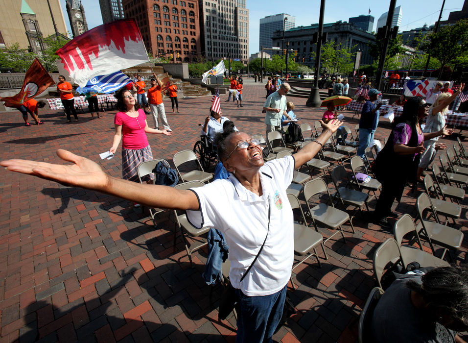 General News - 3rd placeJoann Ross, 71, of S. Euclid, raises her hands in praise as she sings during the 61st Annual Observance of the National Day of Prayer held a Public Square in downtown Cleveland on Thursday.  The prayer service started at 9 a.m. and will be filled with prayer, live music and scripture reading.  (Lisa DeJong  / The Plain Dealer)