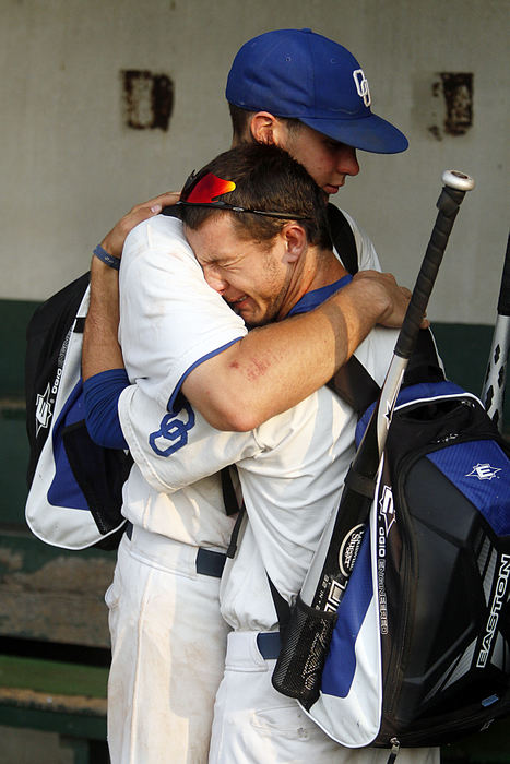 Sports feature - 1st placeOrange's Ryan Black and Brady Harris console each other after losing to Grove City after their regional championship game at Dublin Coffman High School. (Chris Parker / ThisWeek Newspapers)
