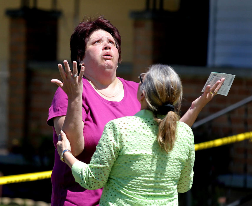 General News - 1st placeCharlene Milan (left) hugs her neighbor Nancy Ruiz, mother of Gina DeJesus, as they celebrate Gina's arrival home. Nancy Ruiz's daughter Gina DeJesus came home yesterday after she was kidnapped and had gone missing for a decade. Three longtime missing women, Amanda Berry, Gina DeJesus and Michelle Knight, were found alive together apparently kidnapped and held for years as prisoners inside a house on Cleveland's near West Side. (Lisa DeJong / The Plain Dealer)