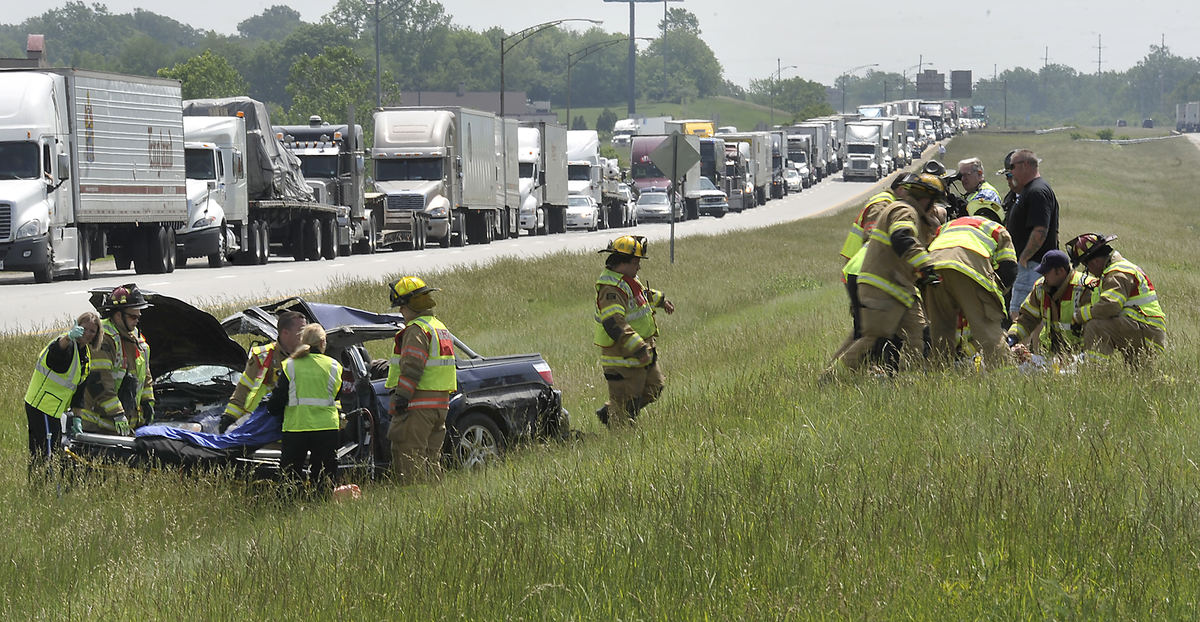 Spot News - 1st placeMembers of the Springfield Township Fire Department treat the driver of a car that rolled several times in the median of Interstate 70 near the State Route 72 interchange in Clark County.  (Bill Lackey / Springfield News-Sun)