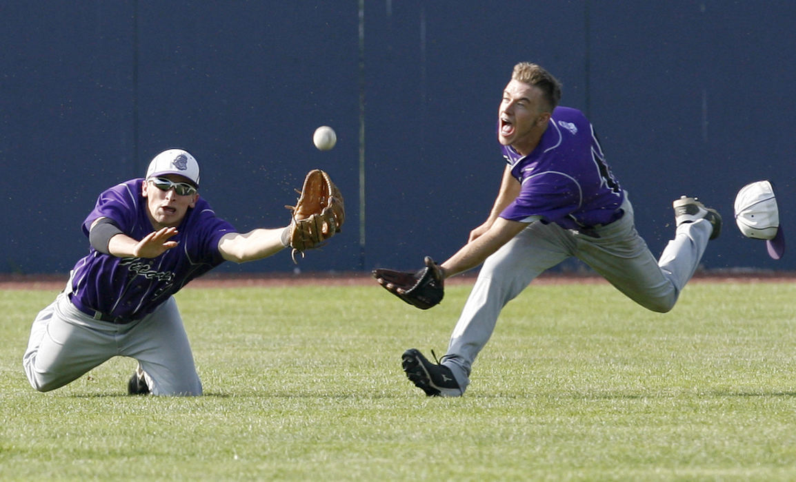 Sports - 1st placeTriway's Greg Hamlin (left) and Jordon Miller dive for a ball hit off the bat of Alliance's Hunter Cannon during the third inning of their Division II district semifinal game at Thurman Munson Stadium in Canton. Both were unable to make the catch on the play. (Scott Heckel / The Repository)