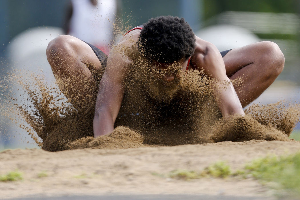 Sports - 2nd placeMarion-Franklin sophomore Franklin Smith gets a face full of sand as he competes in the long jump event during the City League track and field championships at Whetstone High School.  (Eamon Queeney / The Columbus Dispatch)