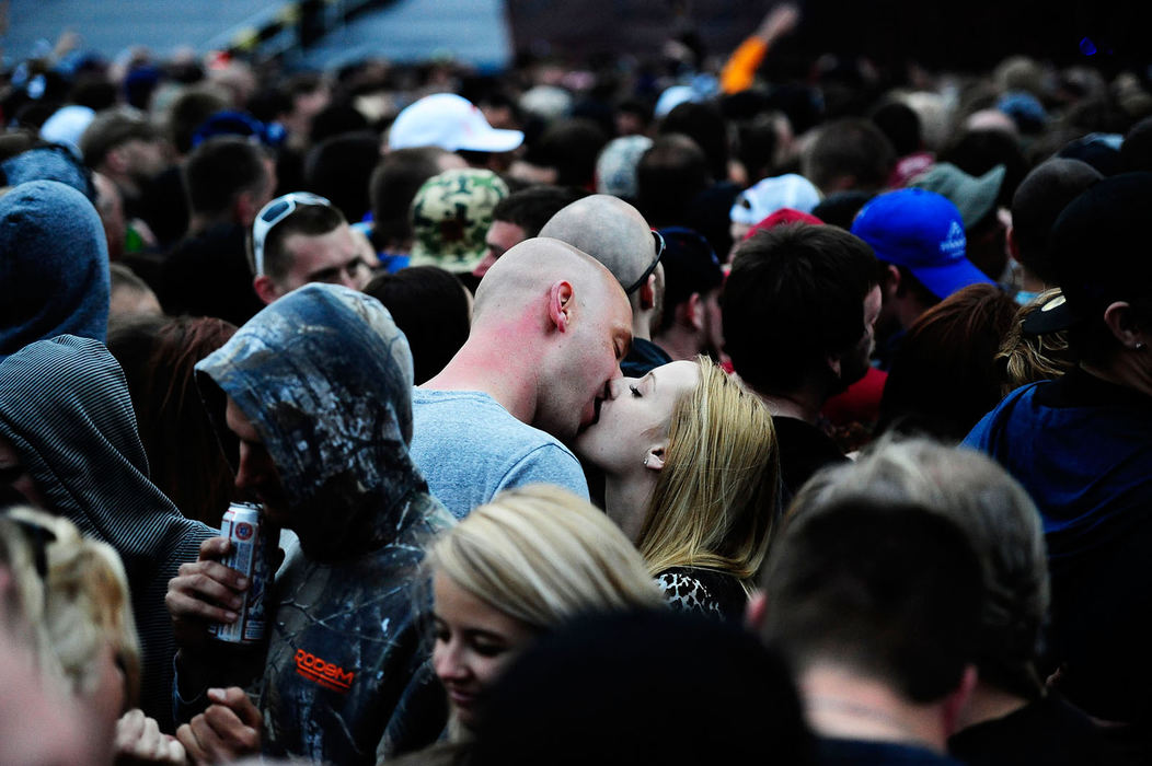 Feature - 3rd place - A couple enjoy a quiet moment with each other amongst the crowd during the annual Rock on the Range music festival at the Columbus Crew Stadium. Over 103,000 people will have attended the event over the next three days.  (Logan Riely / The Columbus Dispatch)