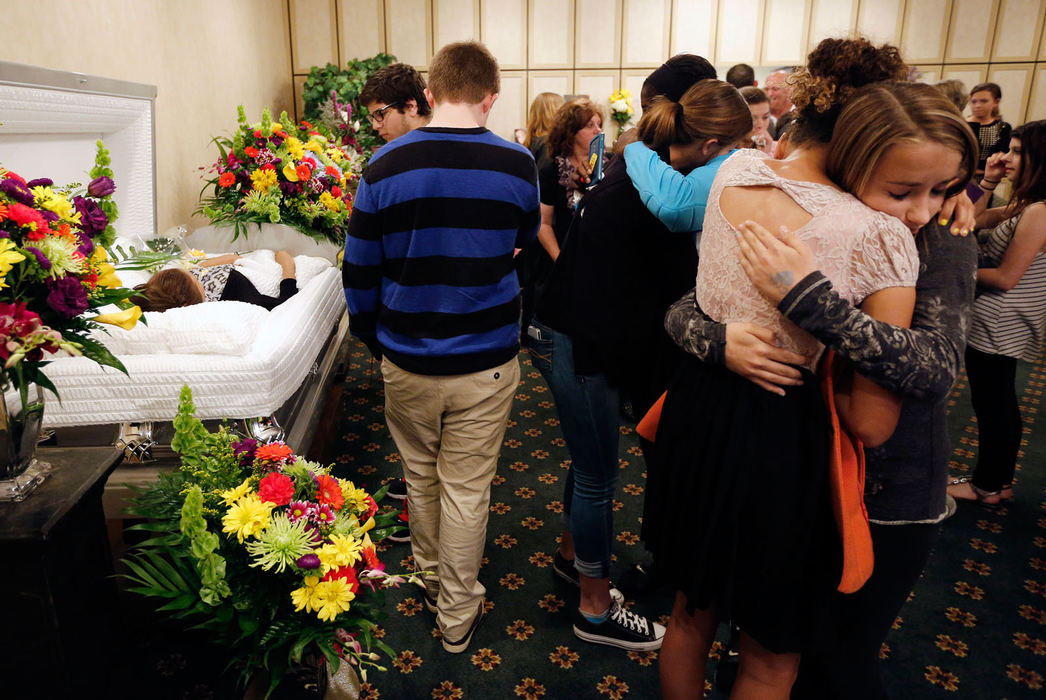 General News - 1st place - May - 1st place - General NewsAdam Cairns, The Columbus DispatchClassmates cry and hug during the viewing for Cora Delille at Dwayne Spence Funeral Home in Pickerington. In her suicide note, Delille, who was 15 years old when she died on May 10, attributed the bullying she endured at school to be a factor in her decision to commit suicide. (Adam Cairns / The Columbus Dispatch)
