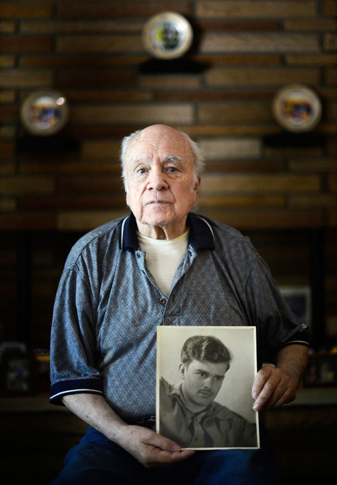 Portrait - 1st place - Billy Power holds an old photograph of Corporal Harold Reed in his home in Toledo. Both Power and Reed served in the armed forces during the Korean War, but Reed perished in the Chosin Reservoir during the conflict. Power has spent decades tirelessly working to ensure that the body of Reed be brought home to the United States and laid to rest with the rest of Reed's family.  (Isaac Hale / The (Toledo) Blade)