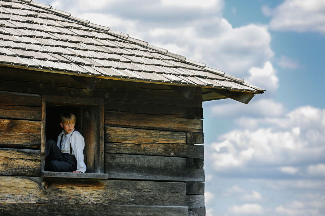 Portrait - 2nd place - Jacob Thompson, 10, watches the action from a window of a log home during the First Siege at Fort Meigs in Perrysburg.   (Andy Morrison / The (Toledo) Blade)