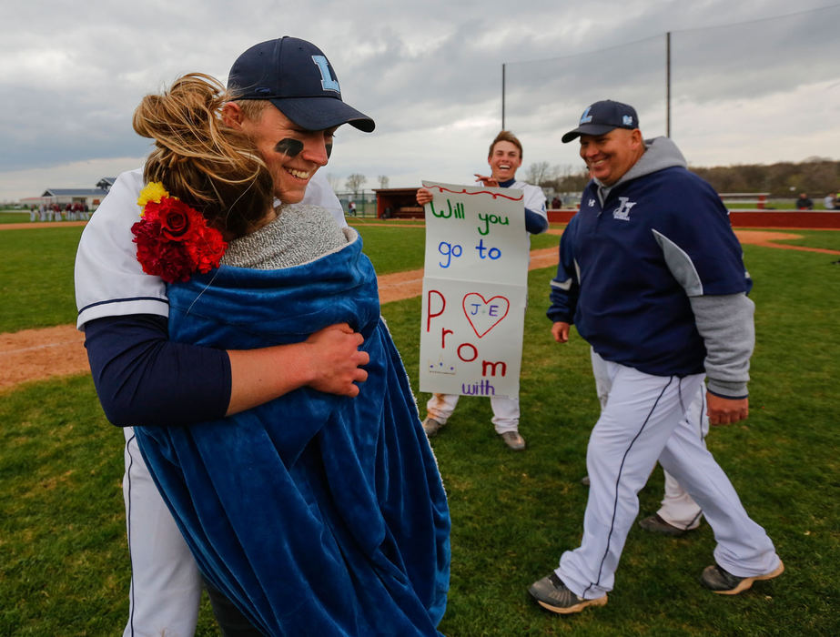 Sports Feature - 2nd place - Lake High School player Joel Densic gets a hug from senior Emily Ervin after she accepted his prom proposal, Friday.  Densic surprised Ervin with the proposal after the Flyers defeated Genoa High School 2-1.  (Andy Morrison / The (Toledo) Blade)