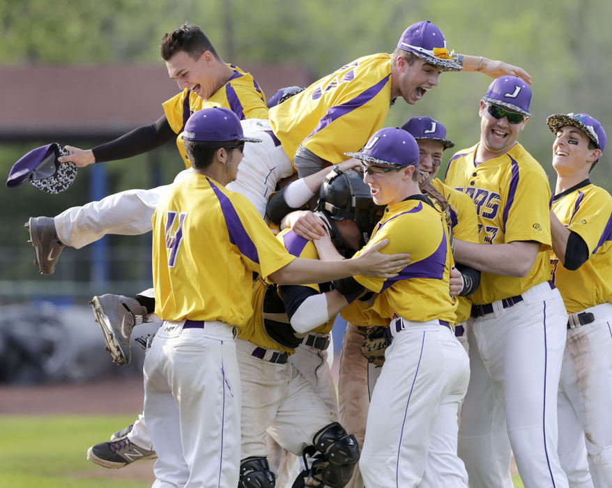 Sports Feature - HM - Jackson players converge on pitcher Ryan Gusbar (front right) after the final out of their Div I district championship game against Lake at Thurman Munson Stadium in Canton. Jackson won 8-4. (Scott Heckel / The (Canton) Repository)