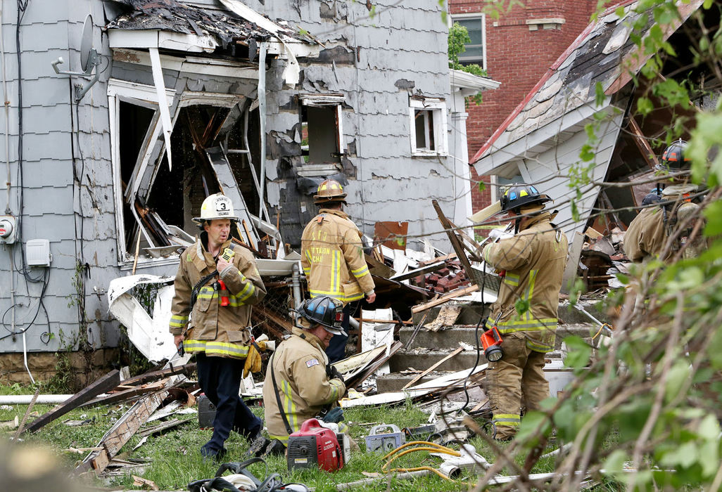 Spot News - 2nd place - Columbus firefighters stand in the back yard of an east side home on Lilley Ave. that exploded. The house that exploded is at right. The damaged house on the left is the house that is next door to the exploded home. (Fred Squillante / The Columbus Dispatch)