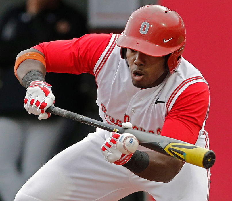 Sports - 3rd place - Ohio State's Ronnie Dawson (4) tries  lay down a bunt against Northwestern  during their game at Bill Davis Baseball Stadium. (Kyle Robertson / The Columbus Dispatch)