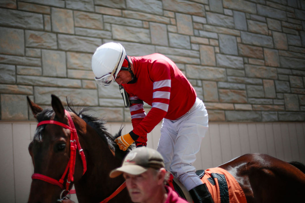 Story - 2nd place - Jockey Edgar Paucar rides out Lil Ms. Wild Cat to the starting gate before the second race at Beulah Park in Grove City. After 91 years of races, Beulah Park will close its gates. It was Ohio's first thoroughbred track. (Joshua A. Bickel / ThisWeek Community News)