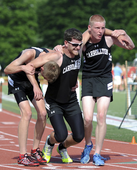 Sports Feature - 2nd place - Carrollton's Quinton Huggett (left) and Cole Lovett (right) help injured teammate Austin Keefer off the track after the 4x800 relay at the Division II Regional Track and Field Tournament at Muskingum University in New Concord. (Shane Flanigan / Zanesville Times Recorder)
