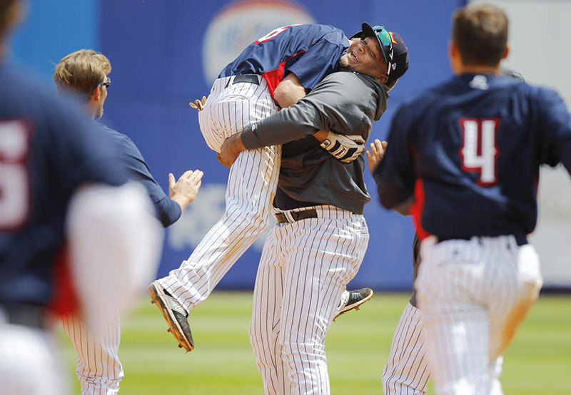 Sports Feature - 3rd place - Toledo Mud Hens pitcher Melvin Mercedes lifts teammate Josh Wilson (6) into the air after Wilson delivered the game-winning RBI as the Hens beat the Gwinnett Braves 5-4 in 12 innings at Fifth Third Field.   (Andy Morrison / The (Toledo) Blade)