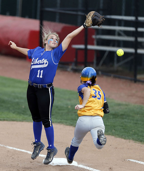 Sports - 3rd place - Olentangy Liberty first baseman Kaylin Lee (11) can't make the catch at first as Gahanna's Lauren Woodward (35) arrives safely in the first inning during a Division I regional softball game at Buckeye Field. This throwing error was one of at least 4 errors by Liberty in the 16-1 loss that ended by the mercy rule after 5 innings.  (Jonathan Quilter / The Columbus Dispatch)