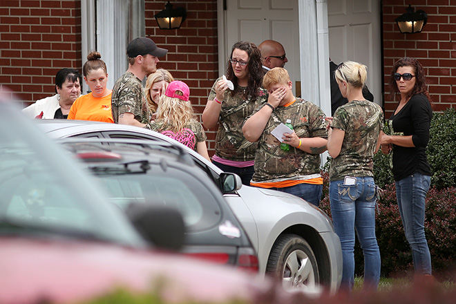 General News - 3rd place - A steady stream of family and friends came together to offer comfort and support during the eight-hour visitation at Roger W. Davis Funeral Home in West Portsmouth for six members of the Rhoden family. They were all slain April 22 in Pike County. (Amanda Rossmann / Cincinnati Enquirer)