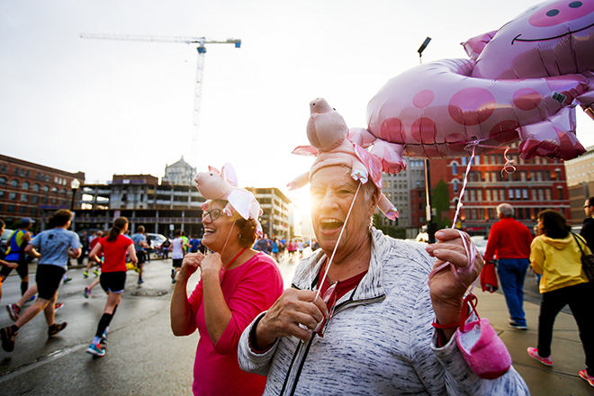 Sports Feature - 1st place - Marsha Ladenburger (right), of Villa Hills, and Janet Chaney, of Monford Heights, cheer on their brother on Seventh Street at the 18th annual Flying Pig Marathon. (Meg Vogel / Cincinnati Enquirer)