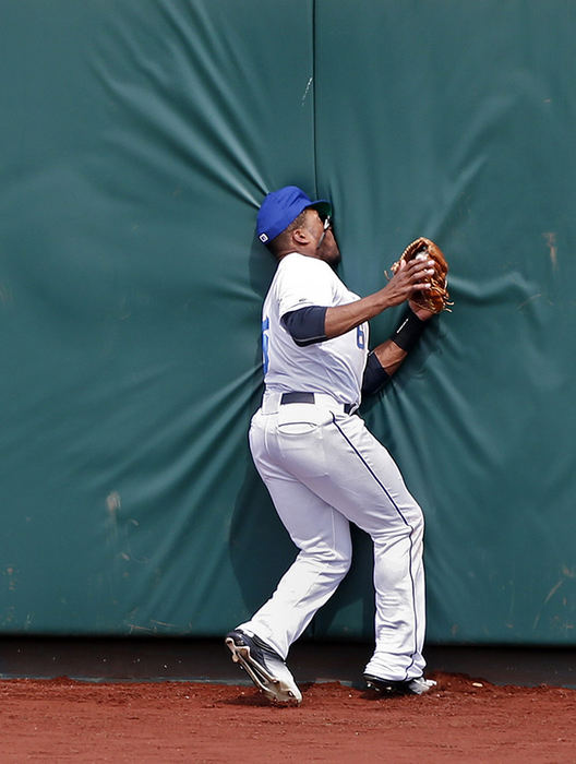 Sports - 3rd place - Bryson Myles  of the Columbus Clippers crashes into the outfield wall after fielding a fly ball against the Louisville Bats at Huntington Park in Columbus. (Barbara J. Perenic / The Columbus Dispatch)