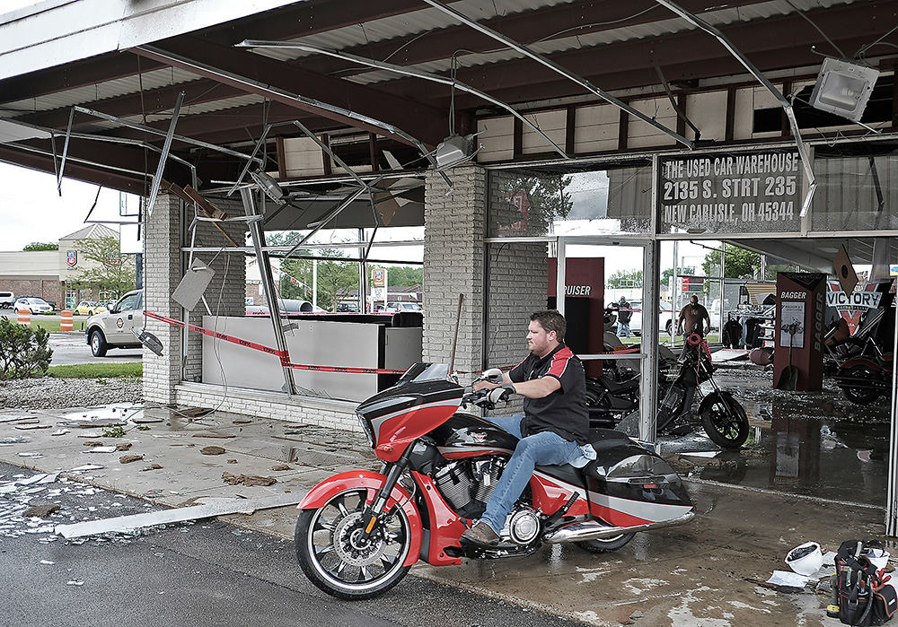 Spot News - 2nd place - A employee of Motor Sports of Dayton rides a motorcycle out of their destroyed showroom. The business in Park Layne suffered heavy damage in a tornado.  (Bill Lackey / Springfield News-Sun)