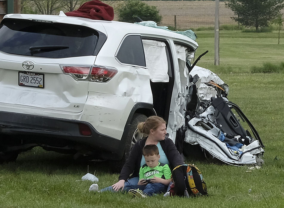 Spot News - 3rd place - A woman sits with a young boy after he was involved in a two car crash on Folk Ream Road in German Township. The boy, who was not in a car seat, suffered a bump on his head and the woman was staying with him to make sure he didn't fall asleep.  (Bill Lackey / Springfield News-Sun)