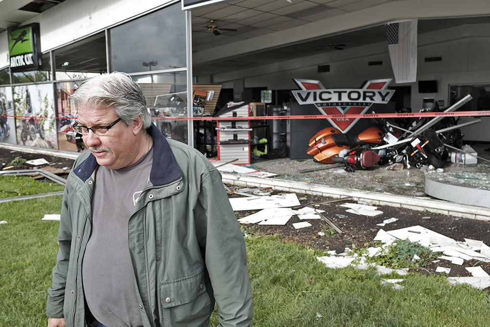 Spot News - HM - Mark Pease, the general manager of Motor Sports of Dayton, walks away from his smashed showroom after surveying the damage caused by a tornado.  (Bill Lackey / Springfield News-Sun)