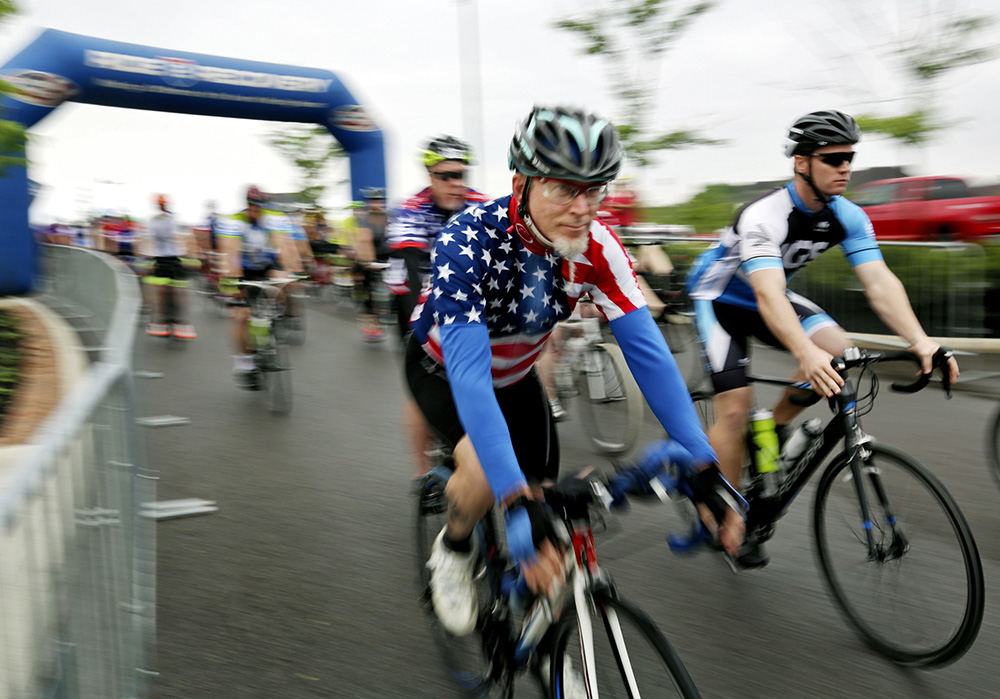 MT Story - 2nd place - Riders roll out of New Albany for the Honor Ride. The bicycle ride is hosted by Project Hero a non profit dedicated to helping injured vets and first responders in recovery. (Eric Albrecht / The Columbus Dispatch)