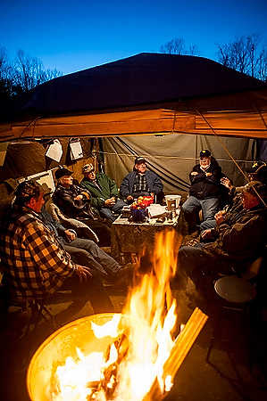 Second place, Larry Fullerton Photojournalism Scholarship - Steven Turville / Ohio UniversityCentury Aluminum retirees gather inside the Occupy Century Aluminum tent as night falls on the site. Retiree Mike Gorrell, foreground left, said, "If somebody would’ve told me fifteen years ago this was gonna happen, that they was gonna try to beat us out of our benefits, I would’ve had a hard time believing it."