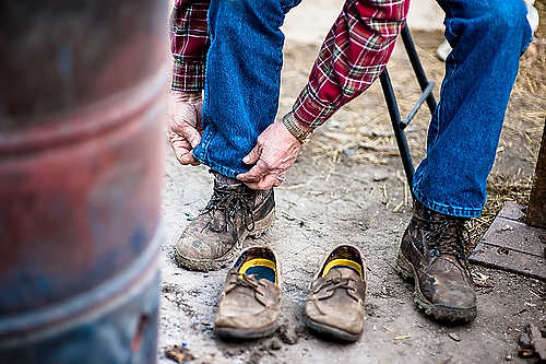 Second place, Larry Fullerton Photojournalism Scholarship - Steven Turville / Ohio UniversityRetiree Bill Stephens laces up his boots shortly after arriving at the Occupy Century Aluminum site.