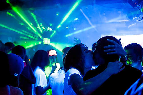 Second place, Larry Fullerton Photojournalism Scholarship - Steven Turville / Ohio UniversityA couple kisses during Dave Rave at The Union Bar and Grill in Athens, Ohio. The black light themed dance is one of the most well-attended electronic dance parties in Ohio.