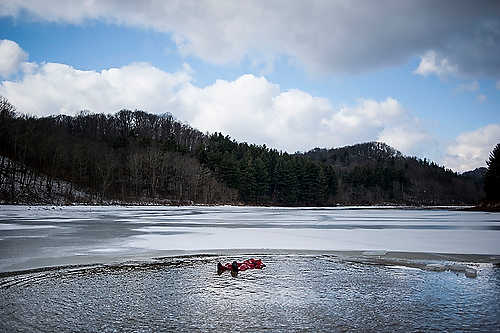 Second place, Larry Fullerton Photojournalism Scholarship - Steven Turville / Ohio UniversityAn emergency response team member lies in the freezing water of Dow Lake in Athens, Ohio, before the start of the annual Polar Bear Plunge. The event raises money for the Ohio Special Olympics.