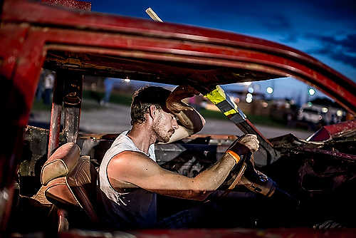Second place, Larry Fullerton Photojournalism Scholarship - Steven Turville / Ohio UniversityJosh Coen of Nelsonville, Ohio, wipes the sweat from his forehead as he is towed back into the pit after the Albany Independent Fair Demolition Derby in Albany, Ohio. Coen has participated in numerous derby events throughout southeast Ohio. “It’s fun when ya win, but it’s fun when ya lose, too,” he said.