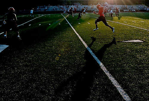 First place, Larry Fullerton Photojournalism Scholarship - Hannah Potes / Kent State UniversityA Hanover Horton High School football player sprints across the field during a 7x7 passing scrimmage at Dungy Field in Jackson, MI.