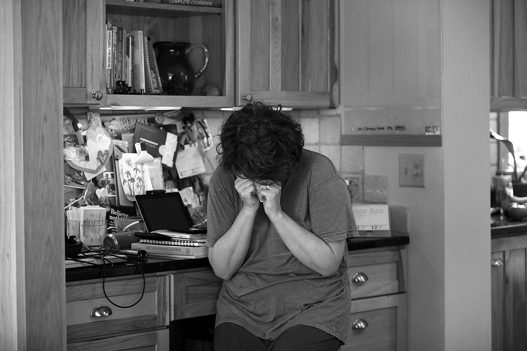 Second place, Feature Picture Story - Carrie Cochran / Cincinnati EnquirerApril 13, 1015: Laurie breaks down in the kitchen as she hears the sobs of the three sons as they visit with their dad upstairs at his bedside. Aaron had driven down from Cleveland and Alex had just got in on a flight from Florida. 