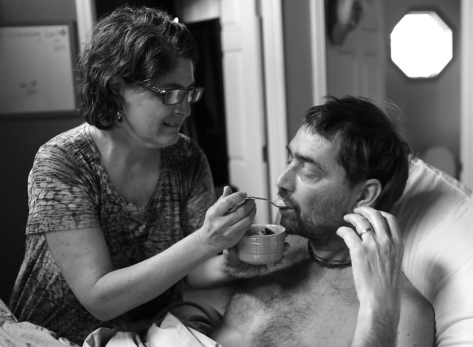 Second place, Feature Picture Story - Carrie Cochran / Cincinnati EnquirerApril 15, 2015: Joe hadn't eaten in days and is delusional, but asked for ice cream. Laurie feeds him Graeter's black raspberry chocolate chip. It will be the last thing he eats. 