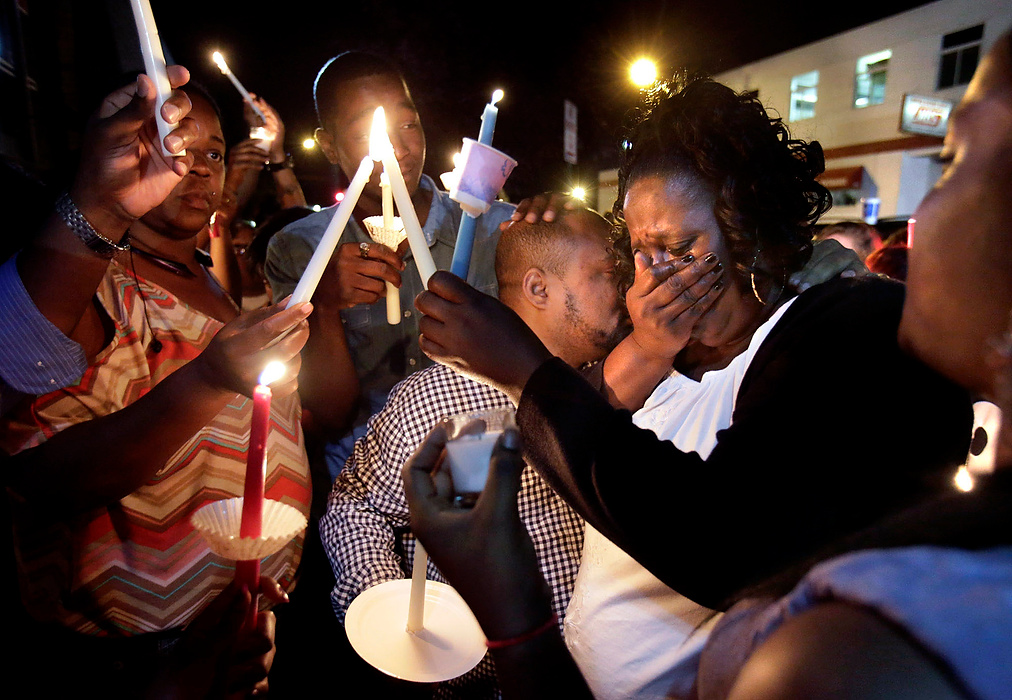Third Place, General News - Scott Heckel / The (Canton) RepositoryTracey Thomas Moreland, right, embraces her bother-in-law Frank Moreland has tears stream down her face during a vigil in Canton for her late son, Derico Rodriques Thomas. Thomas was shot and killed outside the nightclub, "Movement," where the vigil was held.                      