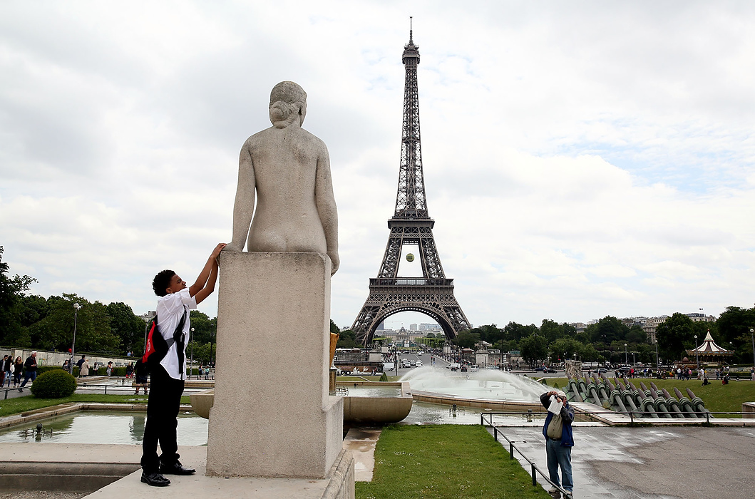 First place, James R. Gordon Ohio Undertanding Award, "Distinguished Gentlemen of Spoken Word" - Lynn Ischay / The Plain DealerMujahid Hamzah reaches up to touch the hand of a statue near the Eiffel Tower. Their host kept them moving through the city so quickly that they had to touch things just to prove to themselves they were really in Paris.