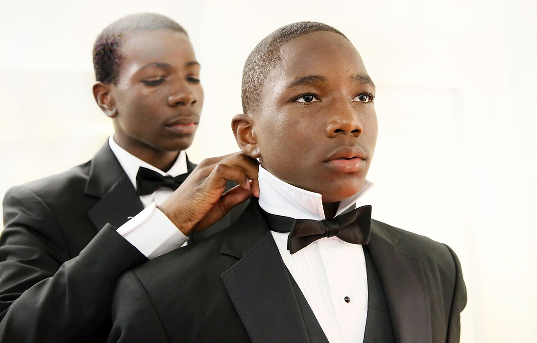 First place, James R. Gordon Ohio Undertanding Award, "Distinguished Gentlemen of Spoken Word" - Lynn Ischay / The Plain DealerMarcus Litman fixes brother Marlon Harper's tie to make sure he looks perfect for their performance. Each year in June, the French celebrate the legacy of Dr. Martin Luther King Junior. The Distinguished Gentlemen were invited to perform for French and US politicians at opening ceremonies at the Hotel de Region in Confluence. 