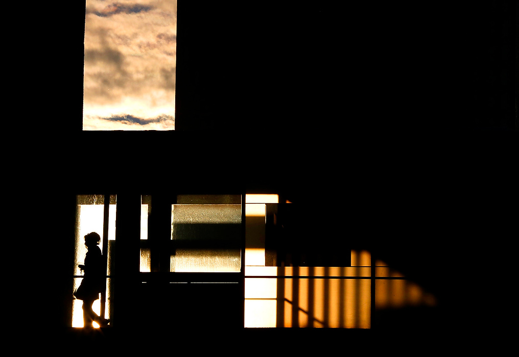 Third Place, Pictorial - Jonathan Quilter / The Columbus DispatchA commuter makes her way to the Capital Plaza parking garage via an elevated walkway at sunset. Sunset was at 6:18pm; by the end of the month it will be 6:23pm. 