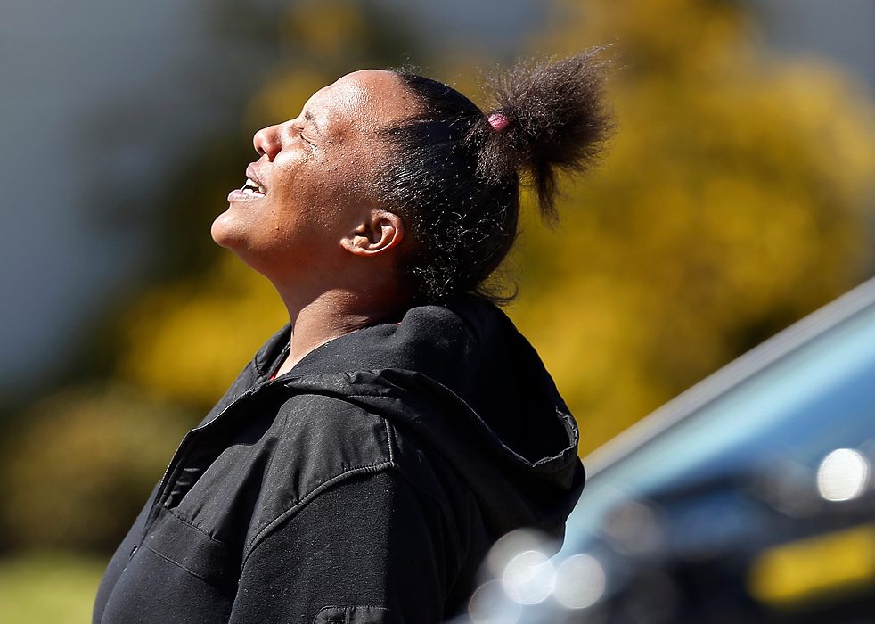 Second Place, Photographer of the Year - Large Market - Adam Cairns / The Columbus DispatchA relative of the victims who declined to give her name cries as she walks near the scene of a shooting on the South Side in which two were killed and a third victim was taken to Grant Medical Center on April 1, 2015. 