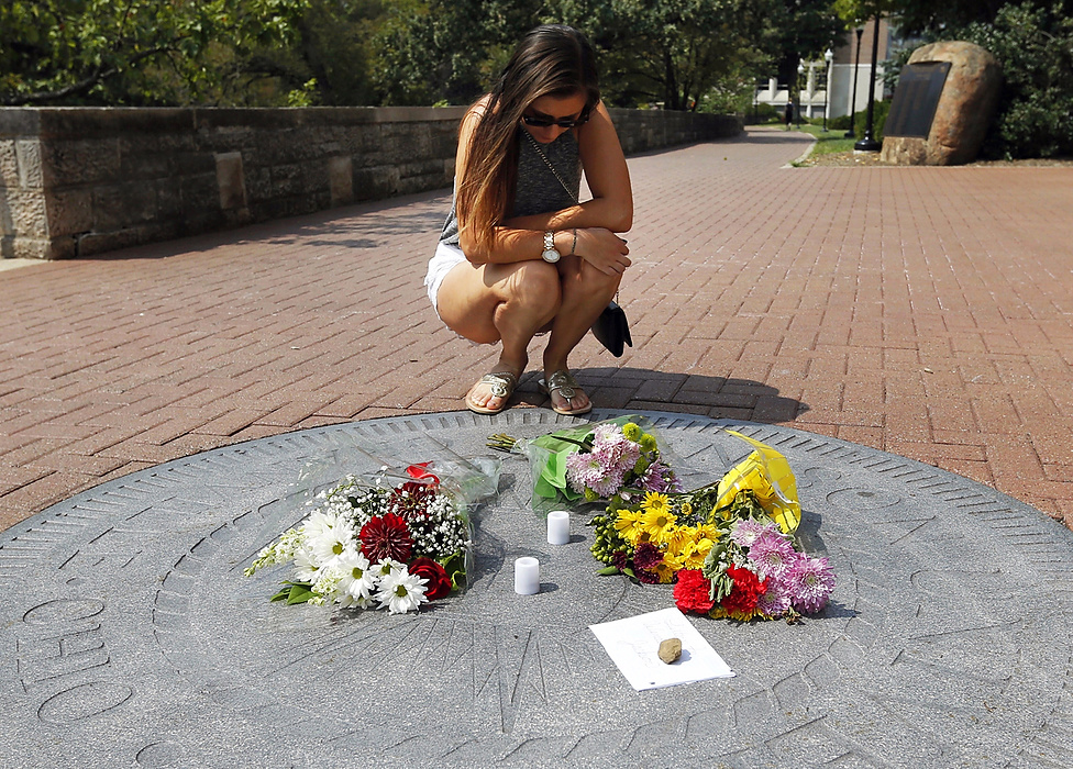 Second Place, Photographer of the Year - Large Market - Adam Cairns / The Columbus DispatchAfter finding out about the death of classmate Wendell Jackson, Meghan Tenorio, 20, places flowers on the Denison University seal in front of Swasey Chapel on the school's campus on Sept. 1, 2015. Tenorio said she didn't know Jackson well, but she saw him almost every day and his smile brought joy to everyone. Jackson's body was found near the campus Tuesday morning. 