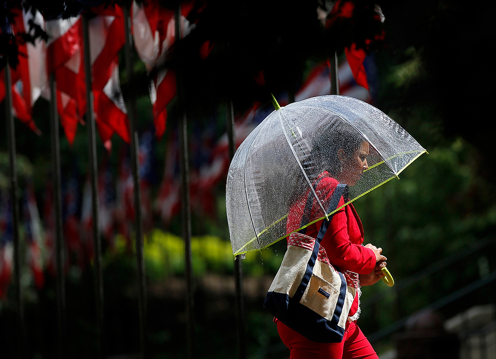 Second Place, Photographer of the Year - Large Market - Adam Cairns / The Columbus DispatchKayla Atchison, 24, of Grandview Heights heads into the Ohio Statehouse for a meeting after a pop-up shower passed through downtown Columbus on May 26, 2015. As quickly as the rain came on, the skies cleared and sun came back out. More thunderstorms are expected to pass through Central Ohio the rest of the evening. 